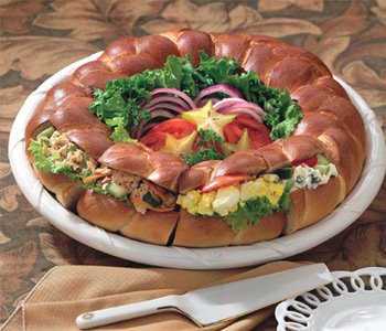 Giant party bagel platter dressed with lettuce and onions