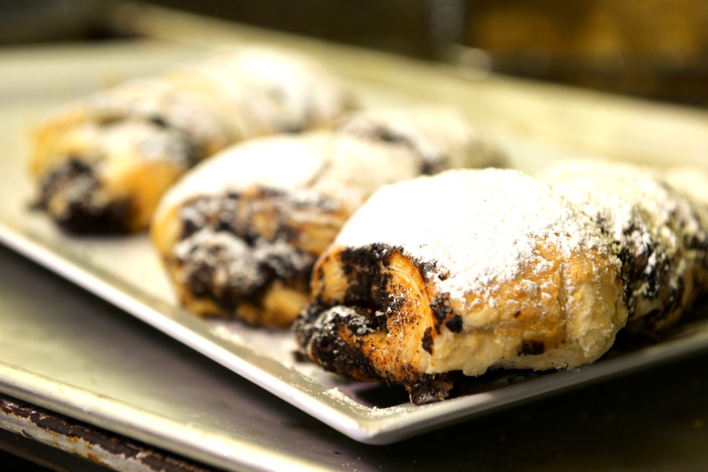 Powdered rugelach on a bakery tray